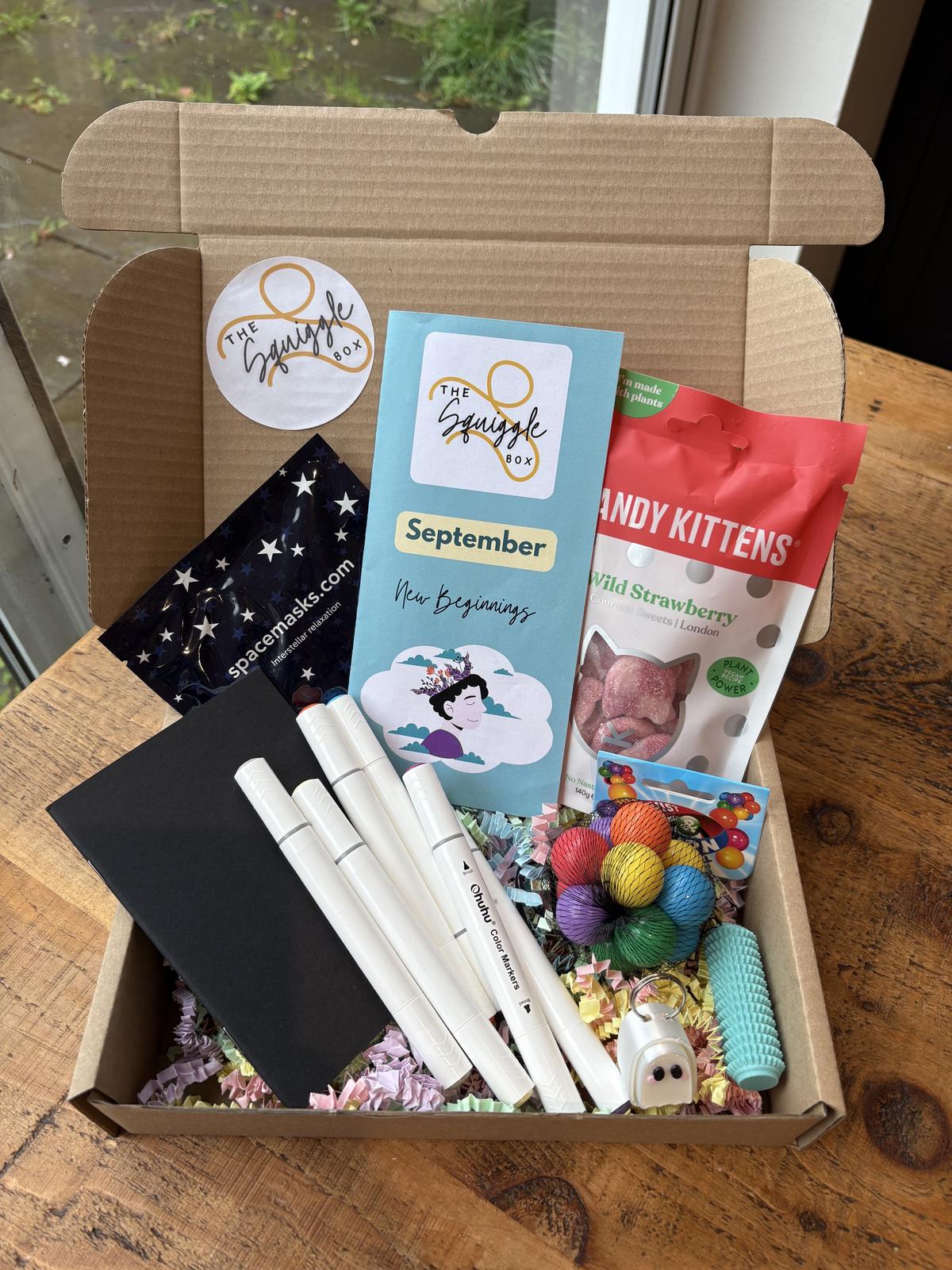 Close-up view of therapeutic art supplies, creative activities and self-care items from The Squiggle Box subscription