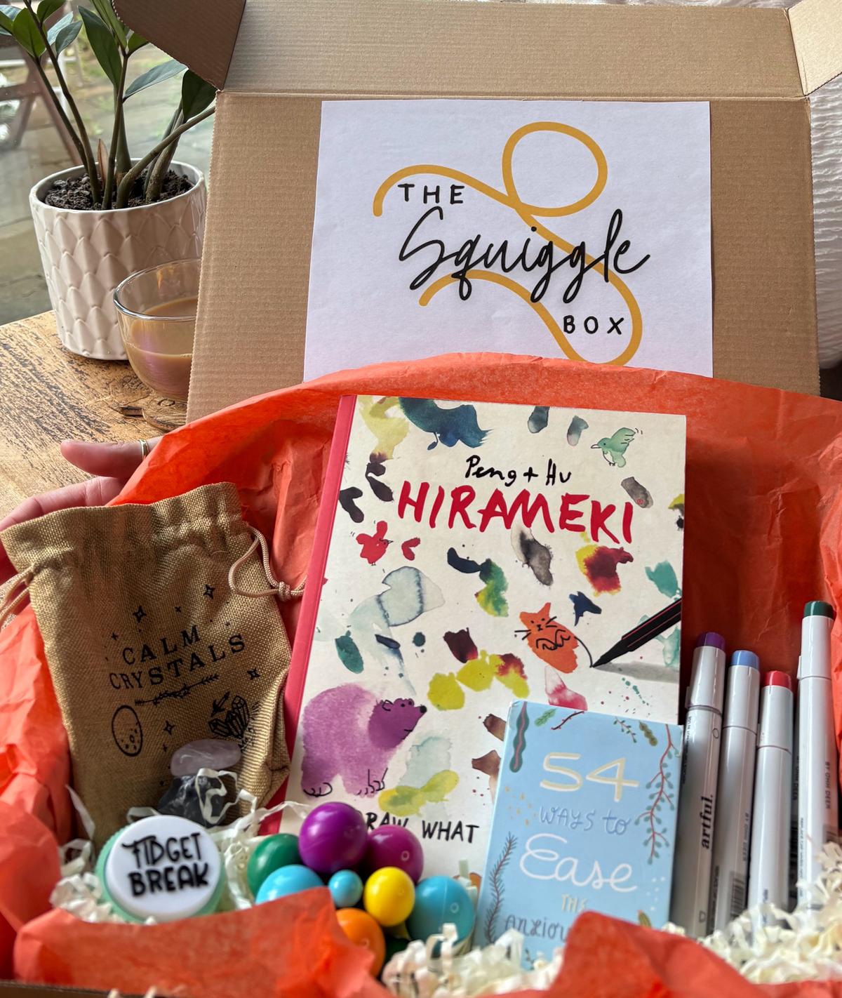 Close-up view of therapeutic art supplies, creative activities and self-care items from The Squiggle Box subscription